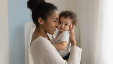 young mother holds newborn