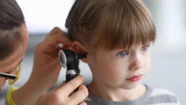 young girl having her hearing tested