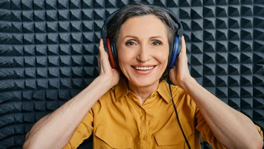 woman having speech therapy test through headphones