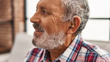 elderly man wearing hearing aid