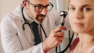 GP conducts hearing test on adult