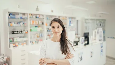 pharmacist in front of pharmacy counter