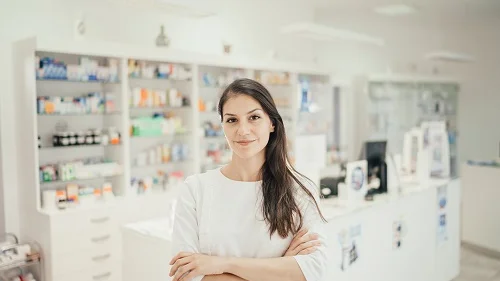 pharmacist in front of pharmacy counter